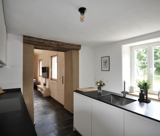 Kitchen with view into the living room